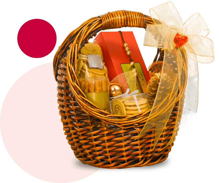 A wicker gift basket filled with cookies, crackers, and a red box, adorned with a large bow.
